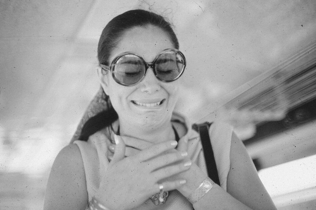 Studio portrait of a young Croatian woman with glasses smiling